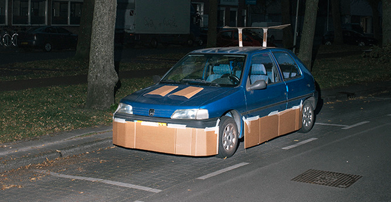 Illustration for article titled This Artist Turns Boring Rides Into Supercars At Night Using Cardboard